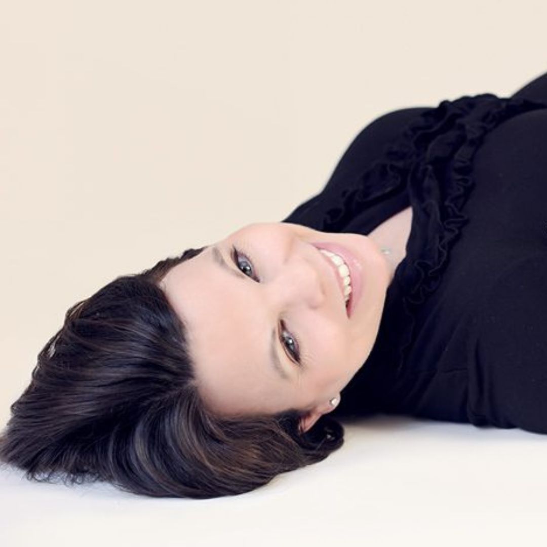 a woman smiling looking up at a camera