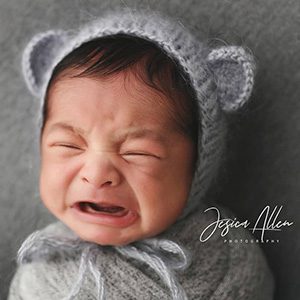 A photoshoot with a crying but still adorable newborn baby
